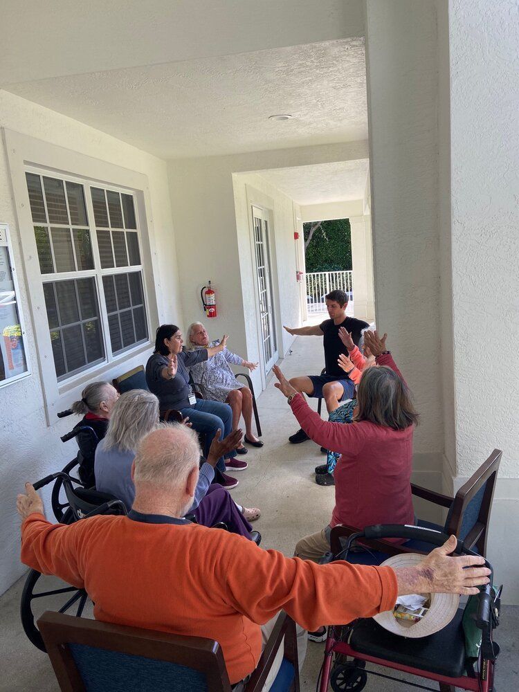 Seated seniors following along with the instructor