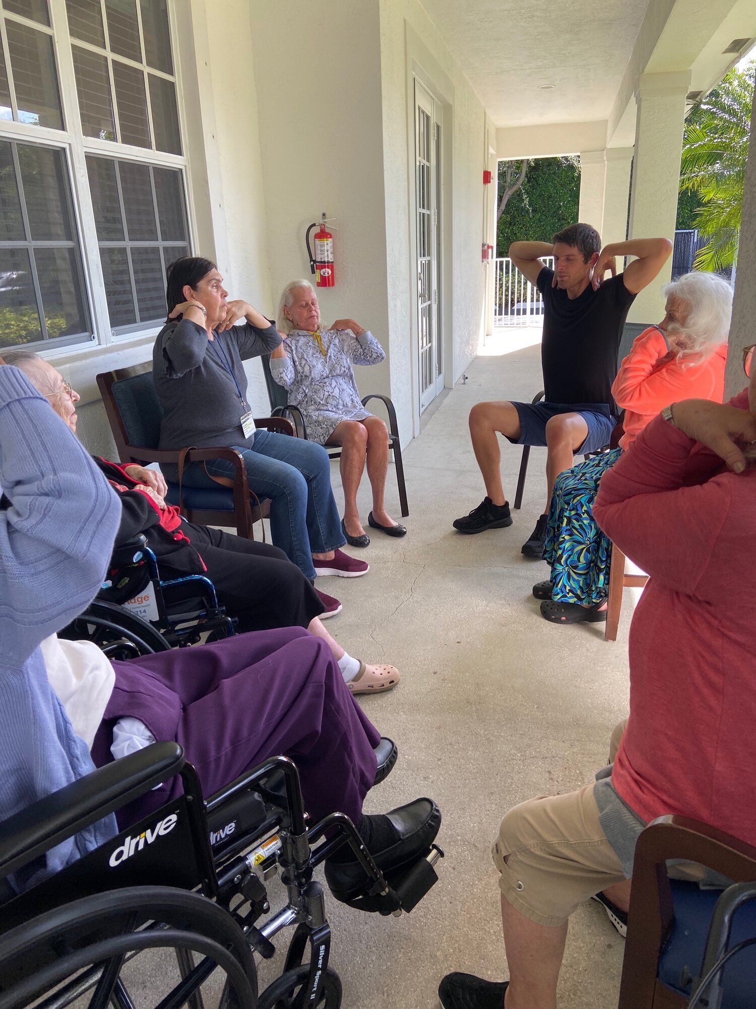 Justin leading a chair-yoga class for senior residents