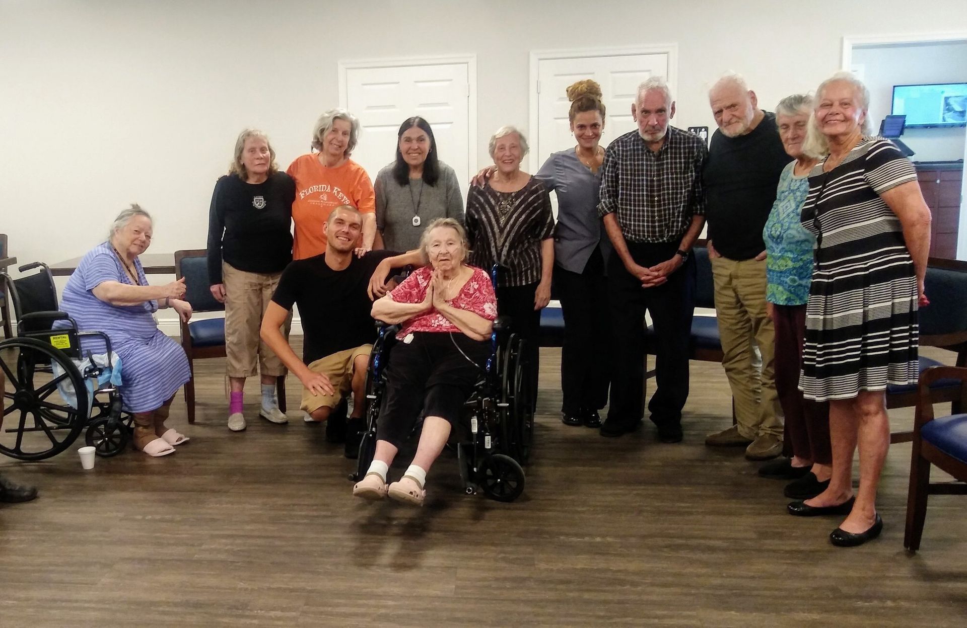 Smiling resident enjoying the chair-yoga class