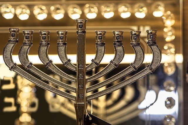 Lit Hanukkah menorah with candles glowing